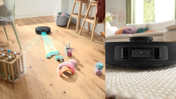 Black Bosch BCRDW3BX robot vacuum cleaning hardwood floor with scattered pet toys.