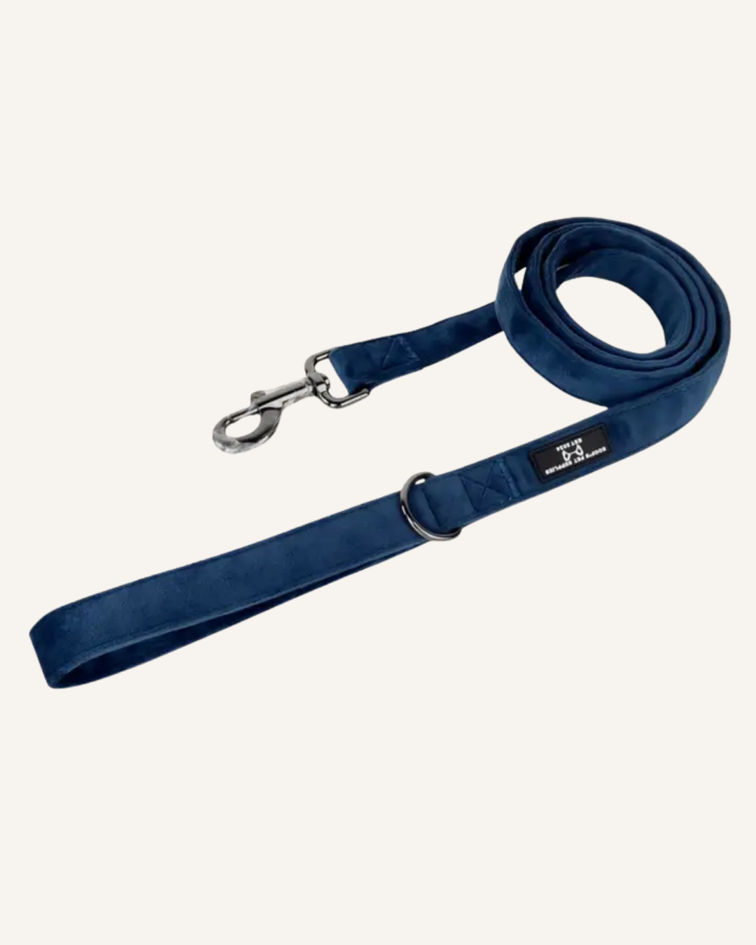 Navy blue velvet dog leash with a silver metal clip, adjustable loop, and stitched logo tag.