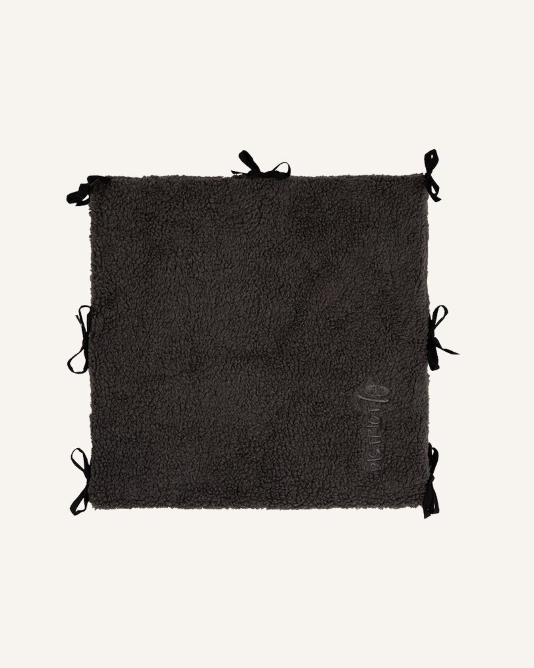 Square dark gray soft sherpa fabric bench divider with multiple black tie straps for securing.