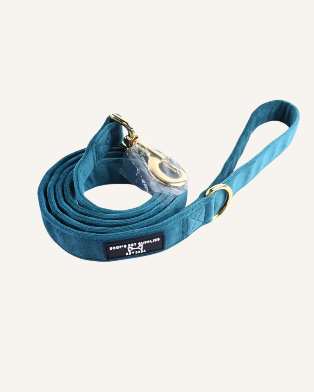 Emerald blue velvet dog leash with a coiled strap, gold-tone clips, and matching wrist loop.