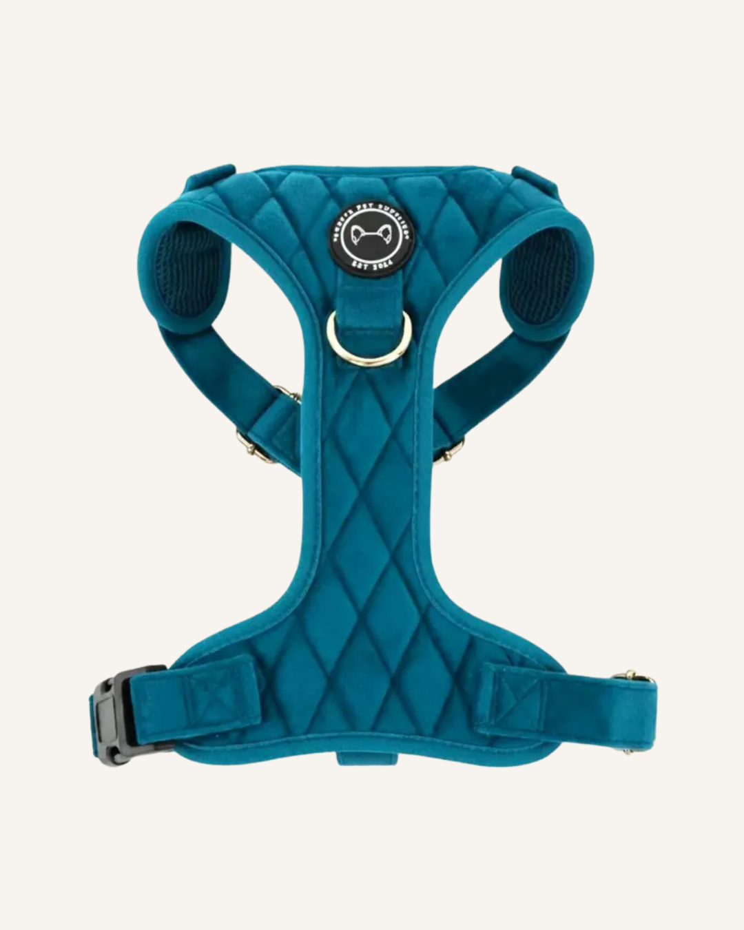 Emerald blue velvet Y-shaped dog harness with quilted stitching, padded straps, and metal rings.