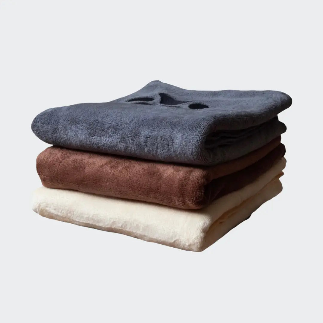Stack of three folded microfiber towels in gray, brown, and beige with a soft texture.