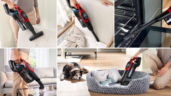 Red and black Bosch cordless stick vacuum BCS1041PET cleaning pet hair from couch, floor, and pet bed.