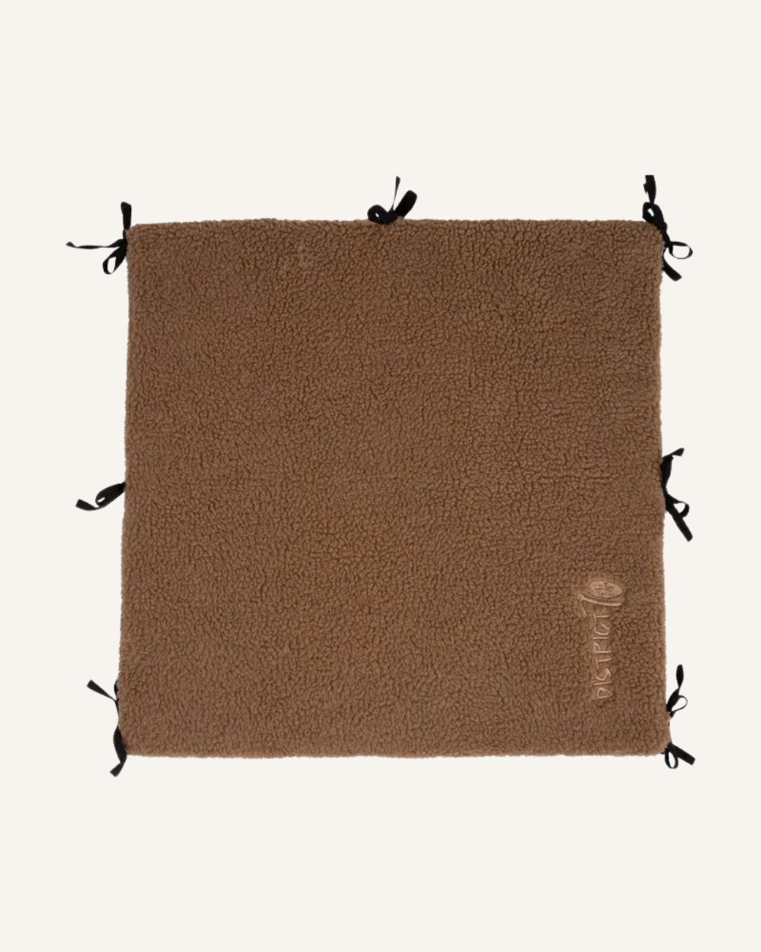 Brown square soft sherpa fabric bench divider with black tie straps on edges.