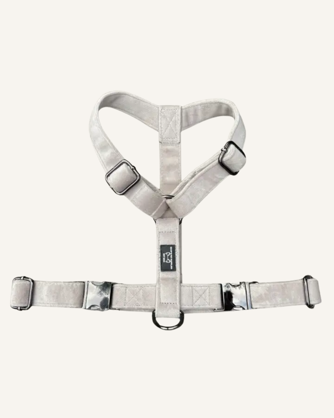 Gray-beige Y-shaped dog harness with adjustable straps, metal buckles, and a leash ring.