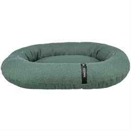 Oval dark green soft fabric dog bed with raised cushioned edges and a small black label on front.